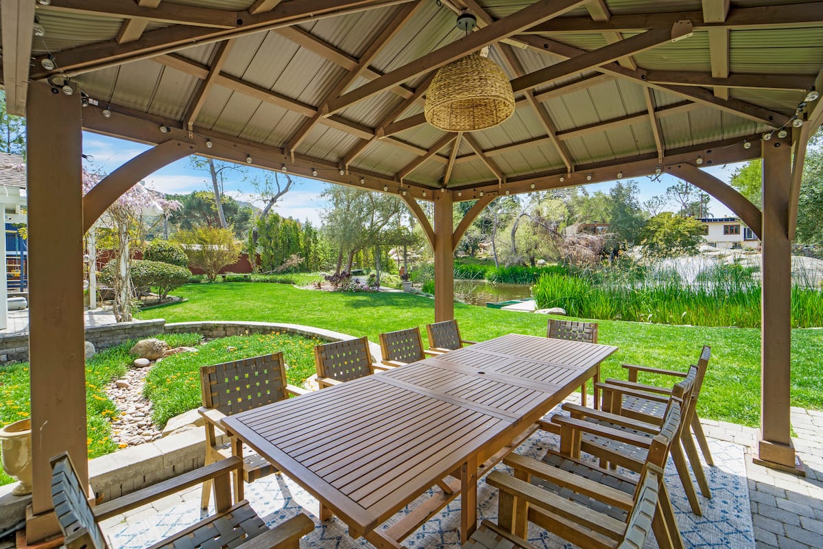 Covered outdoor dining pavilion overlooking the Peaceful Pond House grounds